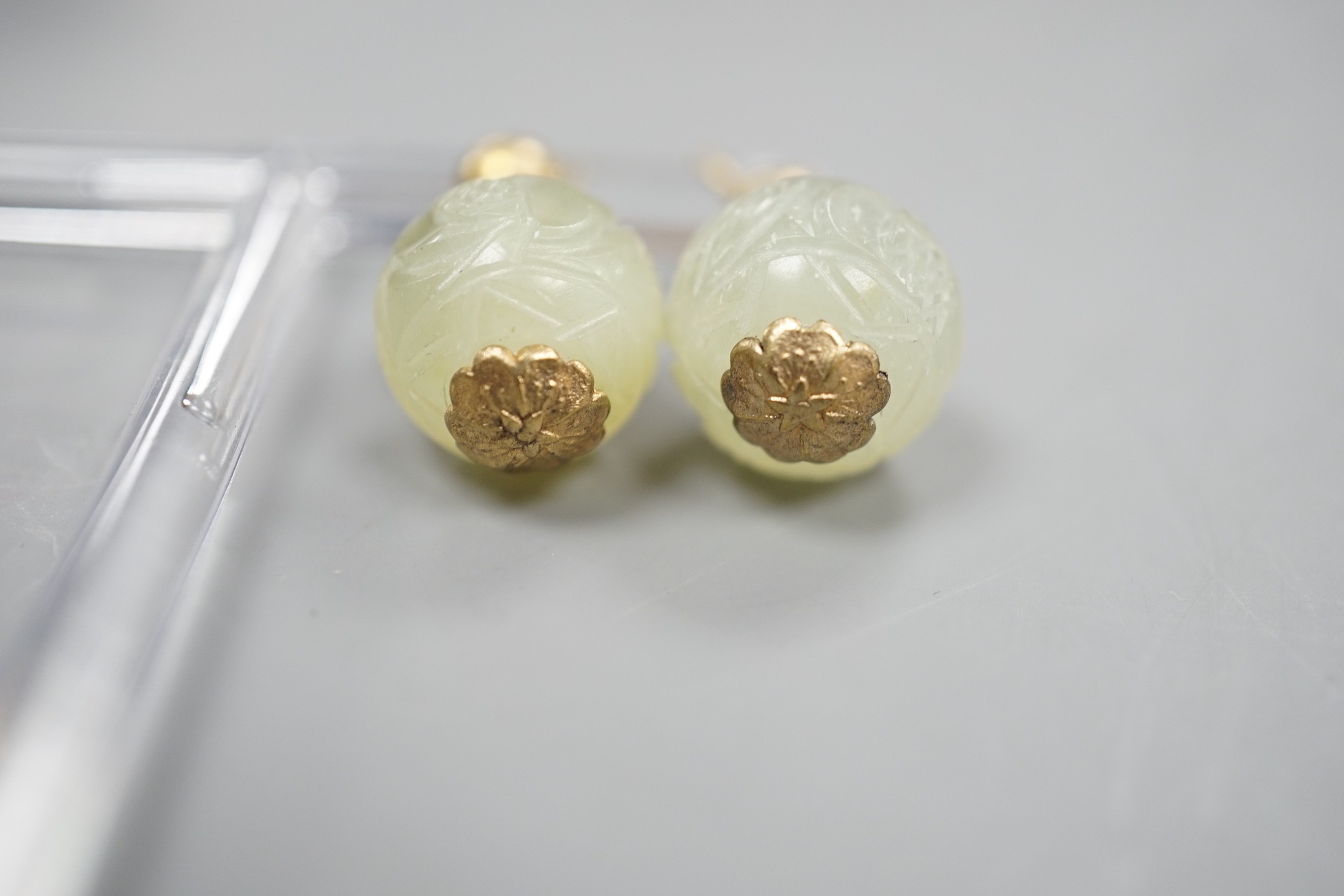 A pair of antique gilt metal and carved hardstone spherical drop earrings, jade diameter 14mm.